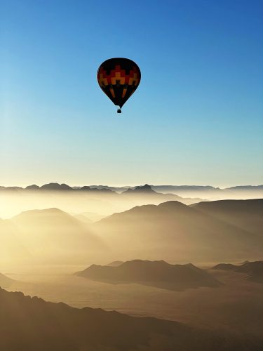 Balloon over misty mountains